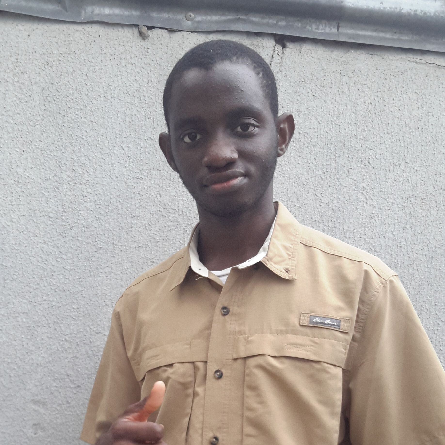 Professional portrait of David Eneasato, Backend Developer and Startup Founder, wearing a casual outfit with a friendly smile